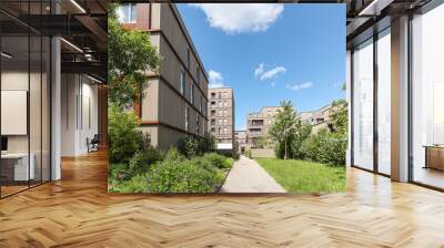 Residential area with ecological and sustainable green residential buildings, low-energy houses with wooden facade, timber construction and green courtyard Wall mural