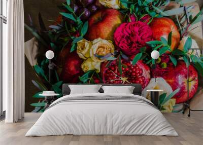 fresh autumn vegetarian fruity bouquet of apples, grapes, pomegranates and roses, with green leaves on a dark background Wall mural