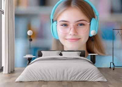 young female student reading book and wearing headphone with blur library on background Wall mural