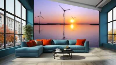 wind turbines and colorful sunrise reflected in water Wall mural