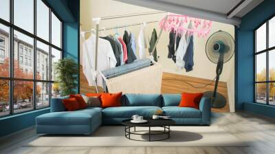 hanging washed clothes in room Wall mural