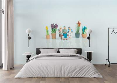 Miniature figurines - 3 generations of people on white background. Wall mural