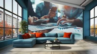 Diverse top managers hold a productive office conference, brainstorming and utilizing digital tools. Business partners strategize on financial reports and investments Wall mural