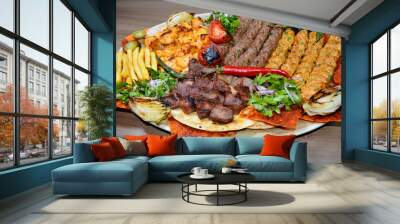 Fast food. Eastern food. Shish kebab, lyulya-kebab, shaverma, pita gyros. Dishes of oriental cuisine lying on pita bread and decorated with greens and vegetables, sauces and French fries. Wall mural