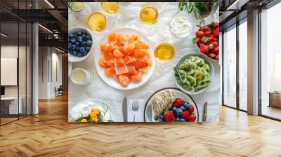 A festive brunch table with mimosas, smoked salmon, bagels, cream cheese, and fresh fruit salad Wall mural