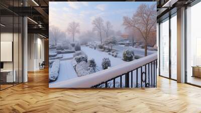 Snowy bridge arches over a frozen forest path, casting long shadows on the icy ground under a winter sky Wall mural