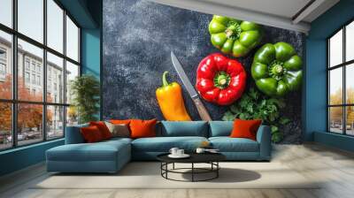 Vibrant assortment of bell peppers with fresh herbs and a knife, perfect for culinary presentations and healthy recipes. Wall mural