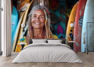 Portrait of senior owner with dreadlocks standing outside of surfboard rental shop Wall mural