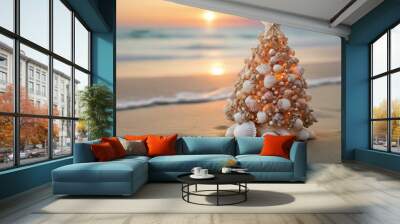 Small seashell christmas tree on the beach with sunset background and copy space Wall mural