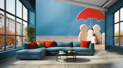 Umbrella symbol and people model on the table. concept of safety protection and health insurance, family security, health care day, car insurance
 Wall mural