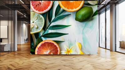 A fresh display of assorted citrus fruits accompanied by tropical flowers on a light background, highlighting the vivid colors and summery freshness. Wall mural