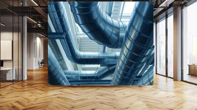 A maze of shiny metal ventilation ducts dominates an industrial ceiling, illustrating complex air distribution Wall mural