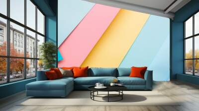 A vibrant display of colorful pastel paper sheets overlapping in an abstract, artistic arrangement, creating a visually pleasing and cheerful pattern. Wall mural