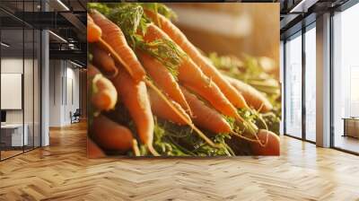 Fresh carrots piled high, bathed in warm sunlight, showcasing their vibrant color and organic allure. Wall mural