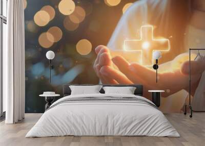 Glowing cross symbol cradled in open hands with warm bokeh background, evoking spirituality and hope. Wall mural