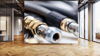 Shiny and durable hydraulic hoses with gleaming metallic fittings, coiled and ready for industrial applications demanding high performance. Wall mural