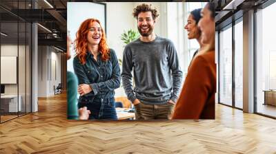 Diverse group of young professionals share joyful moment in bright office Wall mural