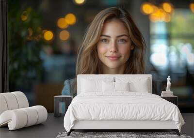 A Young Woman With Long Brown Hair Smiles Confidently in a Modern Cafe Setting Wall mural