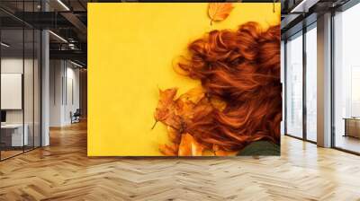 Red-haired woman on autumn leaves with yellow copy space smiling Wall mural