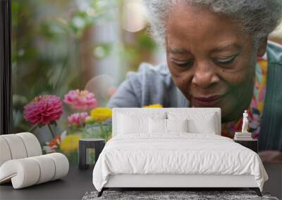 an African American retired woman arranging flowers in her garden Wall mural