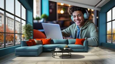 Happy African American teen student elearning at home on pc, writing notes. Smiling teenage girl using laptop watching webinar, hybrid learning english online virtual class, sitting at home table Wall mural