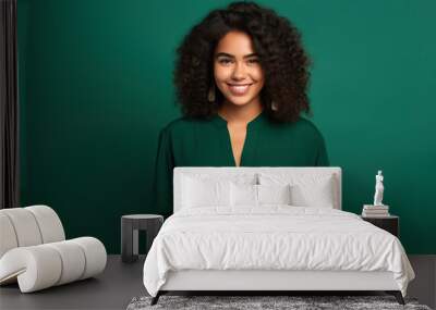 Happy Latin American woman with phone on Emerald studio background Wall mural