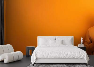 Happy man with cup of coffee on orange background Wall mural