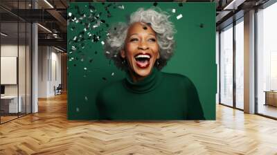 Happy Mature African American woman with Grey Hair Celebrating New Years Party on a emerald Background with Space for Copy Wall mural