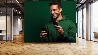 Man with phone on Olive studio background Wall mural