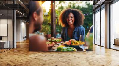 Millennials enjoying dinner party outdoors Wall mural