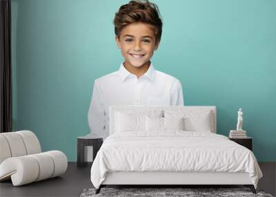 Portrait of cheerful friendly boy wear stylish white clothes isolated on cyan color background Wall mural