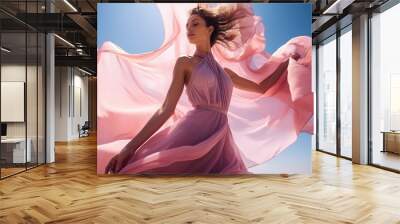 Woman in pink waving dress with flying fabric. Wall mural