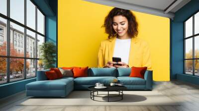 woman with phone on yellow background . AI Generated Wall mural