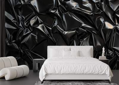 A black crumpled plastic surface with chaotic creases and folds. The glossy, reflective material enhances the texture, giving it a worn, industrial look. Wall mural