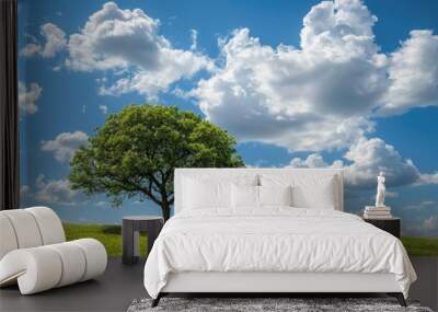 Isolated tree under blue sky and clouds Wall mural