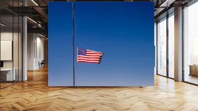 American flag blowing on blue sky at half mast in New York, september 11, USA Wall mural