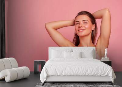 beautiful woman with smooth clean skin raising hands showing perfect shaved armpit isolated on pink background with copy space for text Wall mural