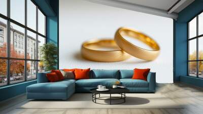 Golden pair of engagement or wedding rings isolated on light grey background Wall mural