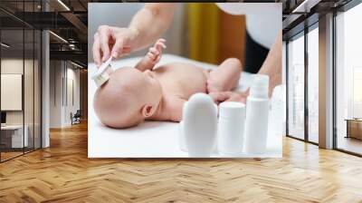 Mom clean baby skin on the head by soft brush for skin care Wall mural