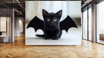 A cute black kitten with bat wings playfully exploring a bright interior on a sunny day. Wall mural