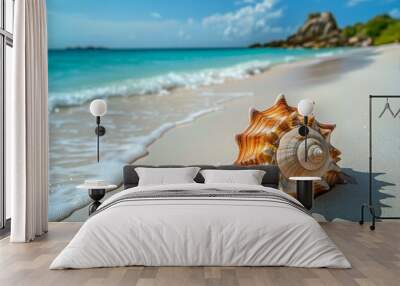 Beautiful summer background with a seashell on a sandy beach and blue sea on a sunny day. Holiday concept. Wall mural