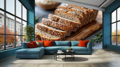 Freshly baked whole grain bread loaf with slices on wooden board, surrounded by scattered seeds. Concept of homemade baking, healthy nutrition, and artisanal food.  Wall mural