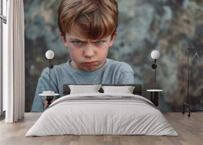 Frustrated young boy overwhelmed by anger and emotions. Wall mural