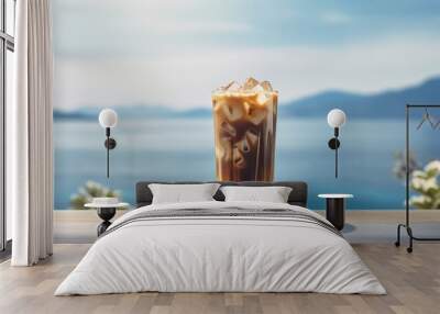 Iced cold coffee at the beach bar with blurred tropical seascape in the background, Generative AI Wall mural