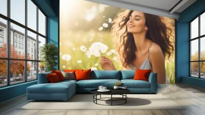 Summer Freedom: Beautiful Young Woman Blowing Dandelion in a Green Field. Allergy-Free Concept. Female Beauty in Nature Wall mural