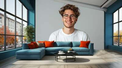 White Male Smiling. Portrait of Student in White T-shirt and Round Eyeglasses, Positively Smiling at Camera Wall mural