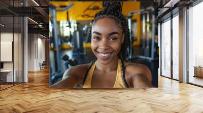 african woman. A woman taking a selfie at the gym after a great workout. Wall mural