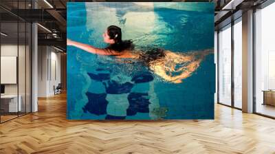 Attractive girl in swimming pool Wall mural