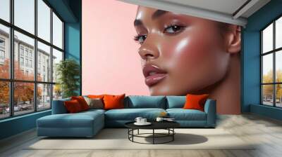 A beautiful model with radiant and healthy skin on a light pink background. Wall mural