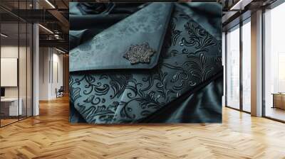 A luxurious black envelope lying on a richly textured satin cloth background. Wall mural